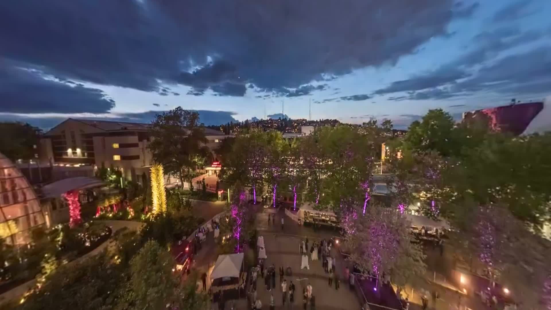 Dusk view over the Chihuly Garden of Glass and Seattle Center during the Block Party festival, shot from the Space Needle's rooftop timelapse rig